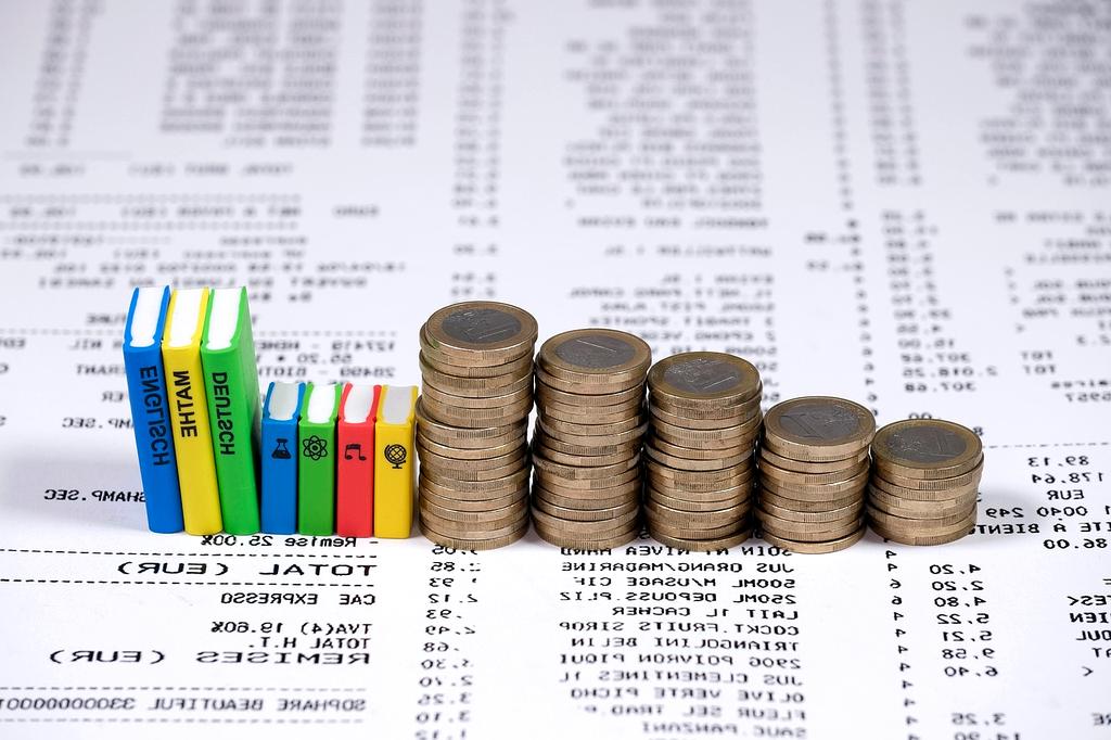 Modern family planning their budget together at a bright kitchen table with financial documents and laptop